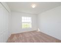 Cozy bedroom featuring carpeted floors, a window, and a closet with bi-fold doors at 2173 Lincoln Ln, Bartow, FL 33830