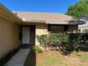 Up close view of a charming single story home, with a welcoming front door and well manicured landscaping at 2408 Fabry Cir, Orlando, FL 32817