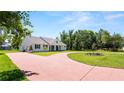 Beautiful curb appeal with a brick driveway, well-manicured lawn and inviting entryway at 2561 Rogers Rd, Lakeland, FL 33812