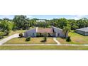 An aerial view of a beautiful home with a large, well-maintained lawn at 34 Misty Meadow Ln, Mulberry, FL 33860