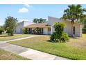 A charming one-story home with a well-manicured lawn and mature landscaping at 34 Misty Meadow Ln, Mulberry, FL 33860