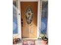 Inviting front door with decorative glass, surrounded by potted plants, adding charm and curb appeal at 4814 Myrtle View N Dr, Mulberry, FL 33860