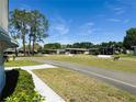 Quiet street in a friendly neighborhood with well-maintained lawns and charming homes at 511 Hawthorne Blvd, Leesburg, FL 34748
