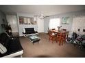 Open-concept living room featuring dining area, neutral paint, and modern furnishings at 1000 S Semoran Blvd # 404, Winter Park, FL 32792
