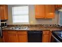 Well-lit kitchen featuring stainless steel appliances, oak cabinets, and double sink at 1000 S Semoran Blvd # 408, Winter Park, FL 32792