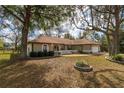 Beautiful one-story home with a landscaped front yard, white picket fence, and attached two-car garage at 10441 Sw 54Th Ct, Ocala, FL 34476