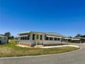 Inviting one-story home with a well-manicured lawn and covered parking at 129 Dogwood Trl, Leesburg, FL 34748