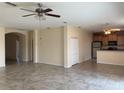Open-concept living room boasts tile floors and connects seamlessly to the kitchen at 1810 Centennial Ave, St Cloud, FL 34769