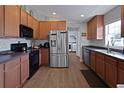 This kitchen features sleek stainless-steel appliances and ample wood cabinetry at 1833 Courtland St, Orlando, FL 32804