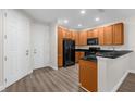 Stylish kitchen with wood cabinets, black appliances, and sleek counter space for cooking and entertaining at 1880 Garden Sage Dr, Oviedo, FL 32765