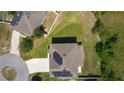 Aerial view of a home with solar panels on roof nestled in a serene landscape at 1940 Bell Creek Loop, Fruitland Park, FL 34731