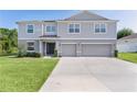 Charming two-story home features a spacious driveway and well-maintained front yard at 1940 Bell Creek Loop, Fruitland Park, FL 34731