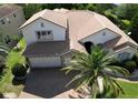 Aerial showcases this two-story house with tile roof, lush greenery, and well-maintained landscaping at 2408 Dahlgren Way, Winter Garden, FL 34787