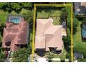 This aerial view shows the home's tile roof, backyard, and proximity to a neighbor's pool and surrounding trees at 2408 Dahlgren Way, Winter Garden, FL 34787