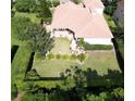 An aerial shot displaying the backyard, complemented by manicured hedges and lush landscaping at 2408 Dahlgren Way, Winter Garden, FL 34787