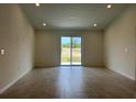 Spacious living room featuring tile flooring and sliding glass doors at 280 Harper Estates Cir, Lake Wales, FL 33859