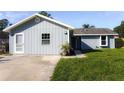 Charming home featuring light blue siding, well-manicured lawn, and a welcoming front entrance at 3426 Somerset Ave, Deltona, FL 32738