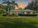 Charming home featuring a manicured lawn, lush landscaping, and decorative window accents enhancing its curb appeal at 39342 Harbor Hills Blvd, Lady Lake, FL 32159