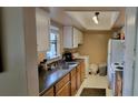 Functional kitchen with white cabinets, dark counters, appliances, and a washer-dryer combo at 4300 Aqua Vista Dr # A, Orlando, FL 32839