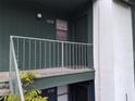 Close up of a second story balcony with green paint, metal railings, and the unit number, 4302 at 4302 Aqua Vista Dr # G, Orlando, FL 32839