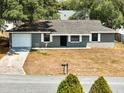 Cozy home with a gray exterior, garage, and a well-manicured front yard at 4680 Sw 142 Place Rd, Ocala, FL 34473