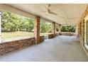 Large, covered outdoor patio featuring brick columns and concrete flooring, perfect for entertaining and enjoying the outdoors at 5155 Holopaw Rd, St Cloud, FL 34773