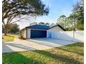 Spacious two-car garage with a large driveway and fenced yard, perfect for extra parking and privacy at 5704 Sw 108Th St, Ocala, FL 34476