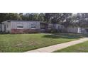 Single-story home with nicely maintained lawn, tidy landscape and long driveway at 7406 Nolton Way, Orlando, FL 32822