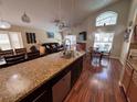 Open-concept kitchen featuring granite countertops, a breakfast bar, and modern stainless steel appliances at 8457 Secret Key Cove, Kissimmee, FL 34747