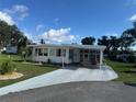 Inviting home with a carport, well-manicured lawn, and curb appeal at 102 Tangelo Cv, Leesburg, FL 34748