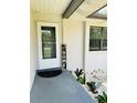 Inviting entrance with a charming welcome sign, white door, and decorative rock landscaping at 10529 Se 50Th Ave, Belleview, FL 34420