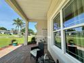 Cozy front porch with comfortable seating and views of the surrounding neighborhood at 10640 Vista Del Sol Cir, Clermont, FL 34711