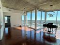 Open living space featuring hardwood floors, modern lighting, and floor to ceiling windows with stunning views at 155 S Court Ave # 1801, Orlando, FL 32801