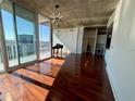 Open living space featuring hardwood floors, modern lighting, and floor to ceiling windows with stunning views at 155 S Court Ave # 1801, Orlando, FL 32801