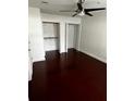 Neutral bedroom with hardwood floors, ceiling fan, and closet storage at 2013 Dixie Belle Dr # 2013K, Orlando, FL 32812
