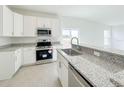 Modern kitchen featuring stainless steel appliances, granite countertops, and ample cabinetry at 2117 Emma Ln, Lake Wales, FL 33898
