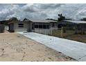 Quaint single-story home showcasing a driveway and neutral gray paint at 2216 Weber St, Lakeland, FL 33801