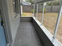 Screened porch with tile flooring, offering a cozy outdoor space at 2216 Weber St, Lakeland, FL 33801