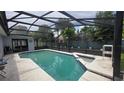 Relaxing screened-in pool area featuring a refreshing pool, spa, and decorative fish accents at 303 Silk Oak Dr, Kissimmee, FL 34743