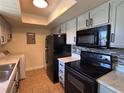 Efficient kitchen with black appliances and light-colored cabinetry, offering modern functionality at 4318 Aqua Vista Dr # K, Orlando, FL 32839