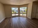 Inviting living room with abundant natural light and views of colorful landscaping and trees at 4318 Aqua Vista Dr # K, Orlando, FL 32839