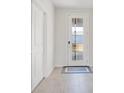 Bright foyer featuring tiled flooring, a modern front door, and white trim at 6066 Arbor Watch Loop, Orlando, FL 32829