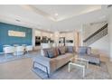 Open-concept living room and kitchen with stylish furniture and modern finishes at 6066 Arbor Watch Loop, Orlando, FL 32829