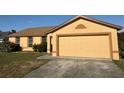 Inviting one-story home with an attached two-car garage and well-kept lawn at 6608 Madeira Ave, Lakeland, FL 33811