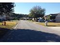 Neighborhood street view showcasing well-maintained lawns, sidewalks, and various home styles in a residential community at 6616 Shepherd Oaks St, Lakeland, FL 33811