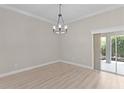 Dining Room boasts modern chandelier, neutral paint, crown molding and access to the lanai at 7214 Se 171St Brookhaven Pl, The Villages, FL 32162