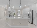 Bright kitchen featuring stainless steel appliances, ample cabinet space, and a breakfast bar at 7214 Se 171St Brookhaven Pl, The Villages, FL 32162