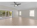 Bright living room featuring vaulted ceilings, light wood floors and sliding glass doors to lanai at 7214 Se 171St Brookhaven Pl, The Villages, FL 32162