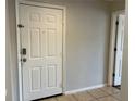 A view of the front door with tiled floor and a glimpse into another room, bright and tidy at 7320 Westpointe Blvd # 531, Orlando, FL 32835