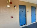 Close-up view of a blue front door with unit number, security features, and an outdoor light fixture at 7320 Westpointe Blvd # 531, Orlando, FL 32835